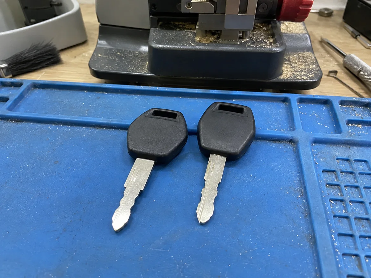 Two transponder keys on a blue work mat