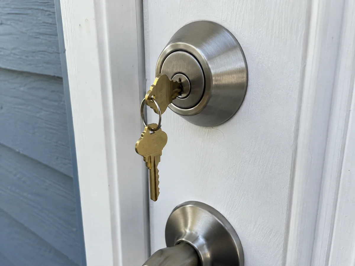 Nickel deadbolt with a house key and spare keyring